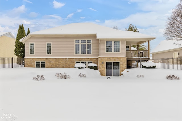 view of snow covered rear of property