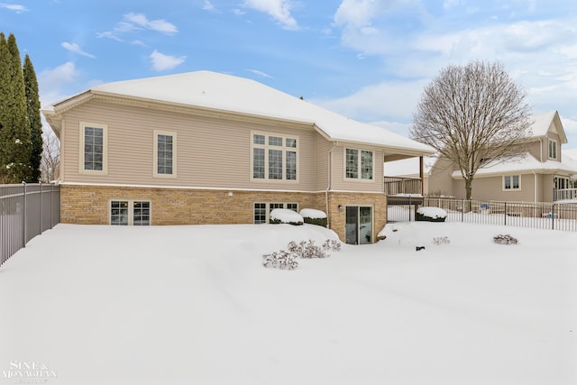 view of snow covered back of property