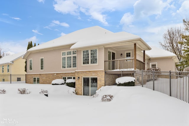 view of snow covered back of property