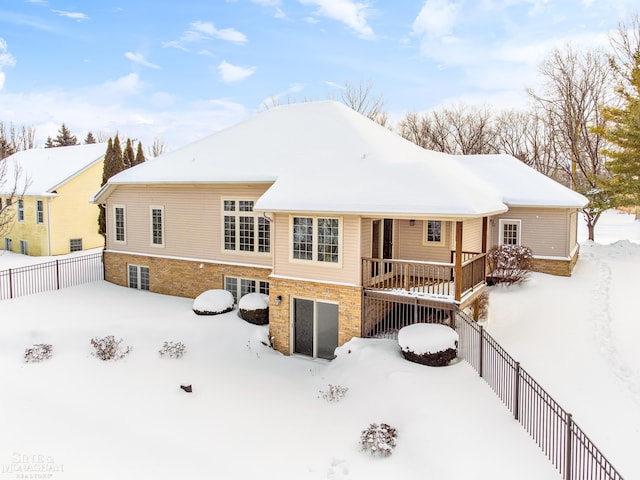 view of snow covered rear of property