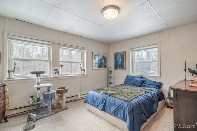 bedroom with a paneled ceiling and multiple windows