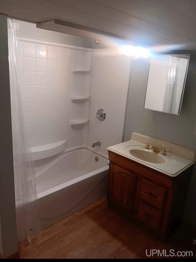 bathroom featuring vanity,  shower combination, and hardwood / wood-style floors