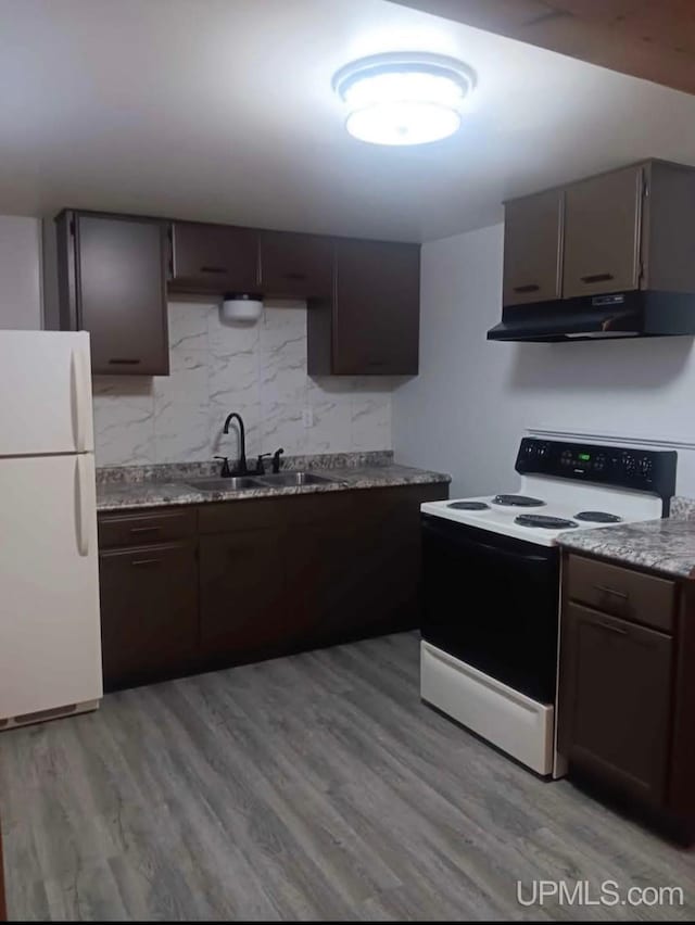 kitchen featuring sink, range with electric cooktop, dark brown cabinets, and white refrigerator