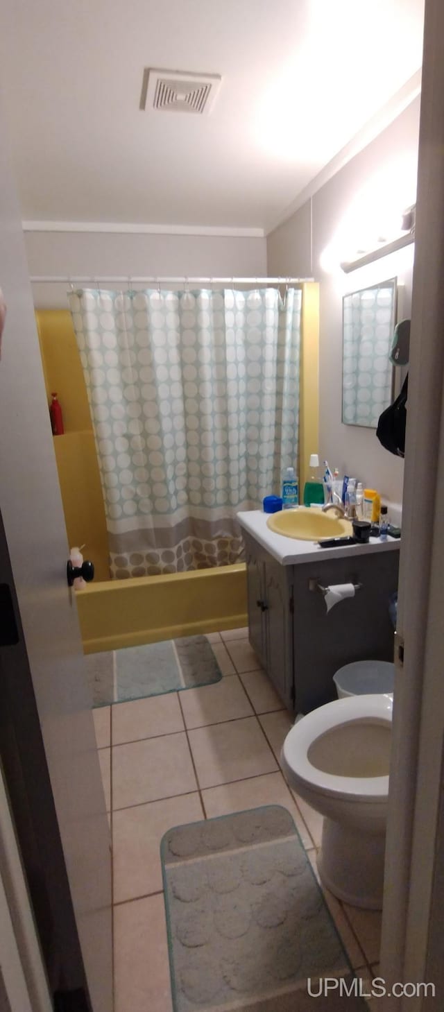 bathroom with toilet, tile patterned flooring, and vanity