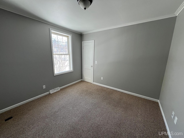 unfurnished room featuring ornamental molding and carpet floors