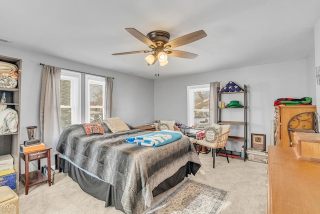 bedroom with ceiling fan and light colored carpet