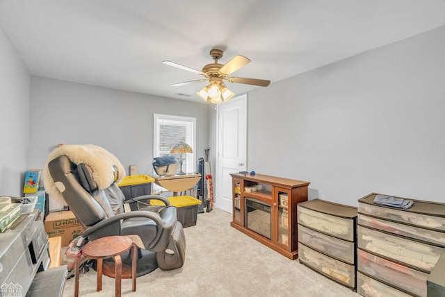 living area with ceiling fan and light colored carpet