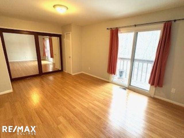 spare room with hardwood / wood-style floors