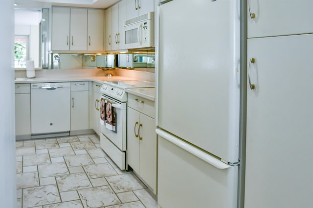 kitchen with white appliances and white cabinets