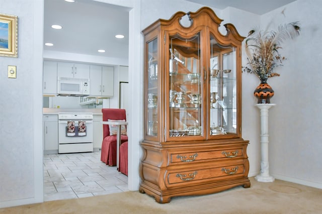 kitchen with white appliances and white cabinets