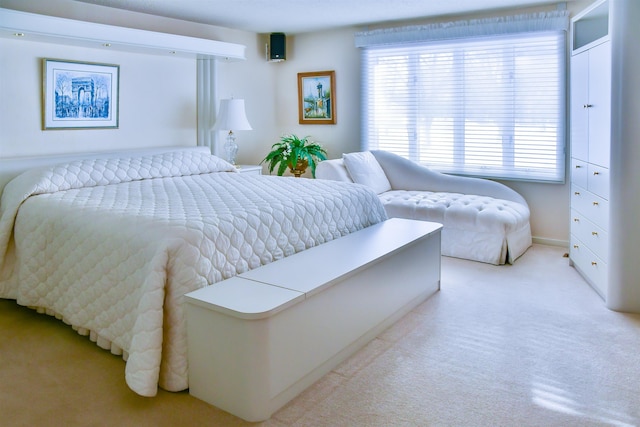 bedroom featuring light colored carpet