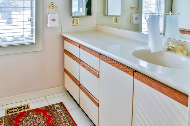 bathroom with tile patterned floors, vanity, and plenty of natural light