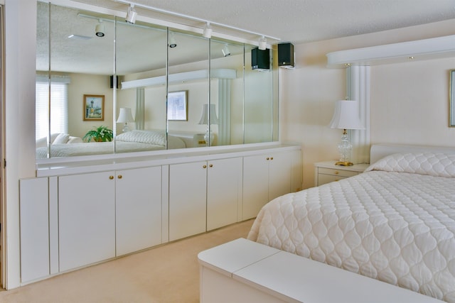 carpeted bedroom featuring a textured ceiling