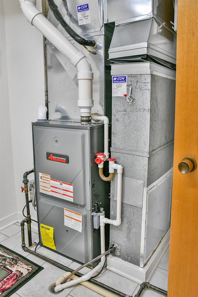 utility room featuring heating unit