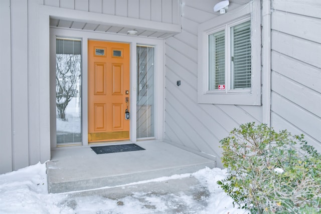 view of snow covered property entrance