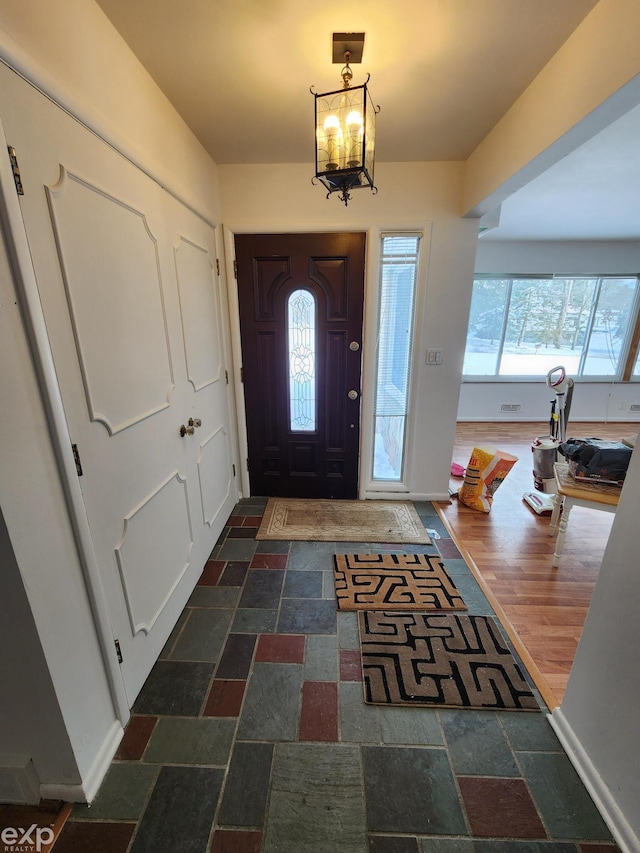 entrance foyer featuring a notable chandelier