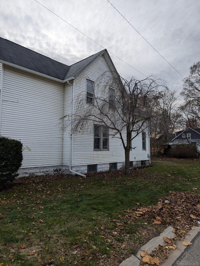 view of side of home featuring a lawn