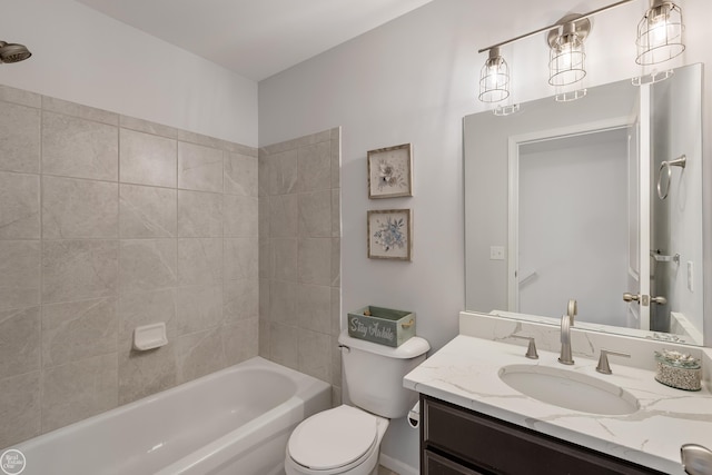 full bathroom with tiled shower / bath combo, vanity, and toilet