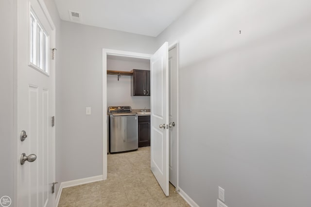 corridor with sink and washer / clothes dryer