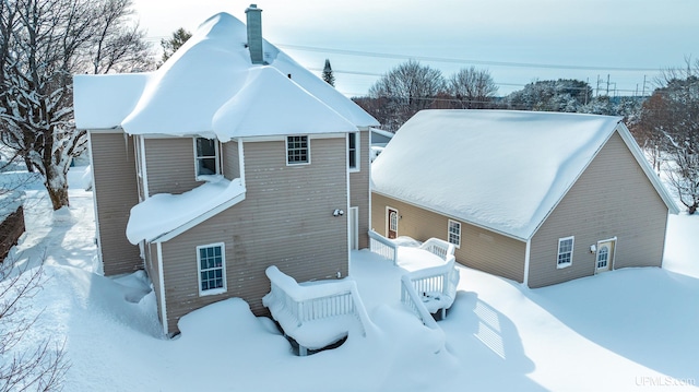 view of snow covered back of property