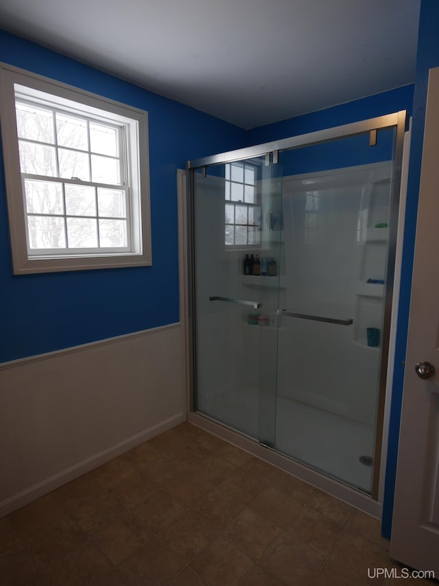 bathroom with a shower with door