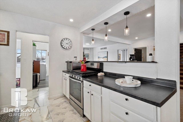 kitchen with marble finish floor, decorative light fixtures, dark countertops, white cabinetry, and stainless steel gas range oven