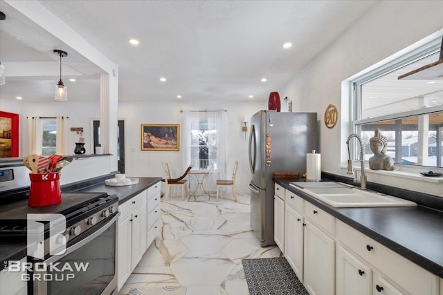 kitchen featuring recessed lighting, stainless steel appliances, white cabinetry, dark countertops, and pendant lighting