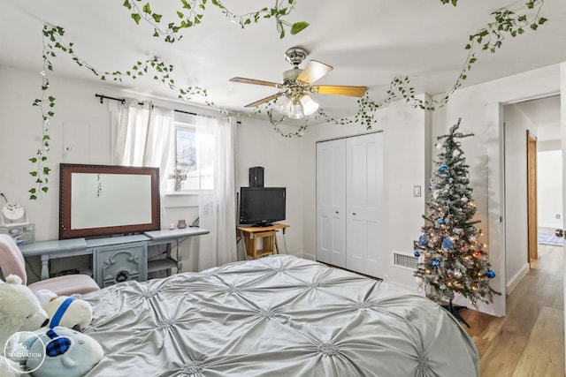 bedroom with a closet, ceiling fan, and light hardwood / wood-style flooring