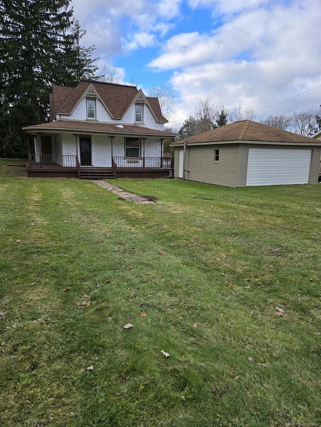 exterior space featuring a garage, an outbuilding, a front yard, and a porch