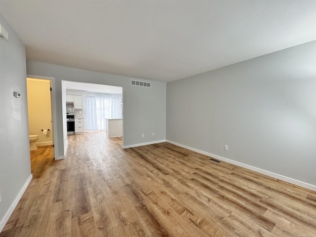 unfurnished living room featuring light wood-type flooring