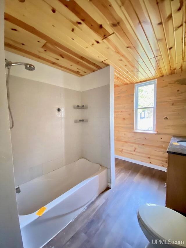 bathroom with wooden walls, wood-type flooring, vanity, wooden ceiling, and toilet