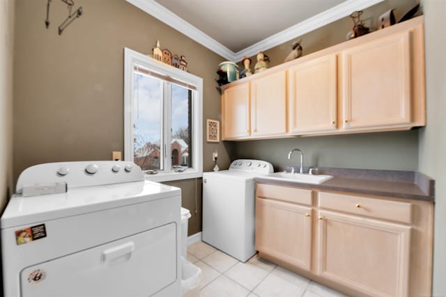 clothes washing area with light tile patterned floors, ornamental molding, sink, separate washer and dryer, and cabinets