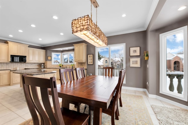 dining area featuring ornamental molding and light tile patterned floors