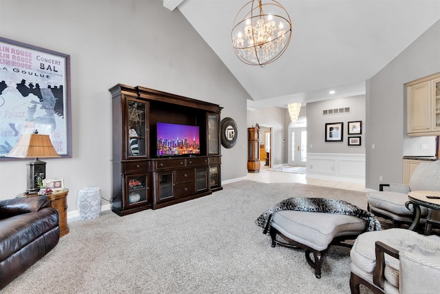 living room with light carpet, high vaulted ceiling, and a notable chandelier