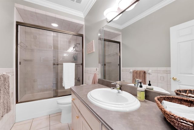 full bathroom with vanity, combined bath / shower with glass door, tile patterned flooring, toilet, and ornamental molding