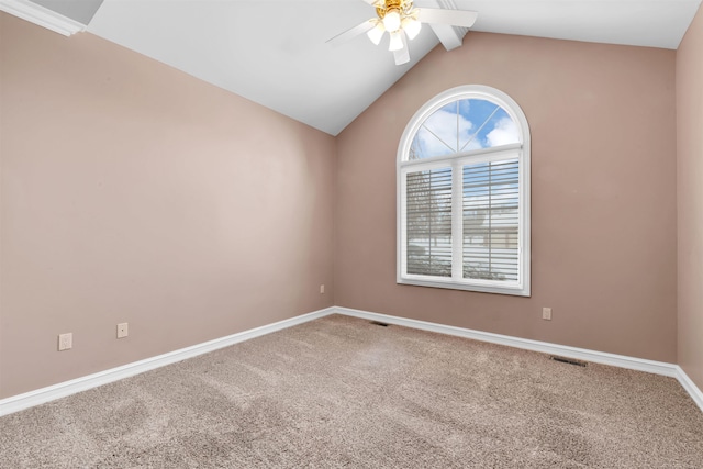 carpeted empty room featuring vaulted ceiling with beams and ceiling fan