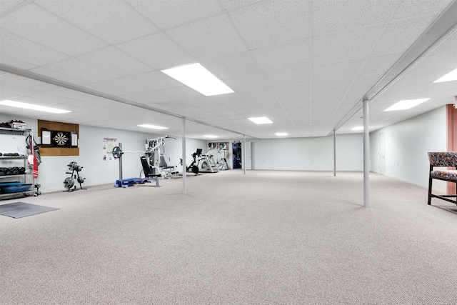 exercise room with carpet and a paneled ceiling