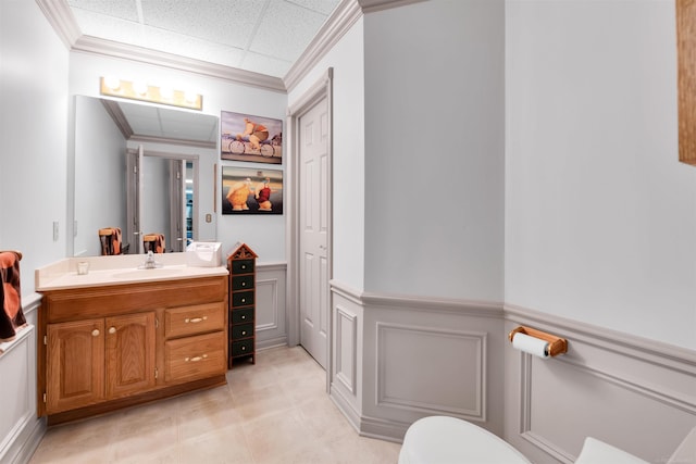 bathroom featuring ornamental molding, vanity, and a paneled ceiling