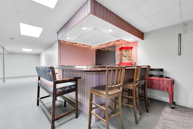 bar featuring carpet flooring and a drop ceiling