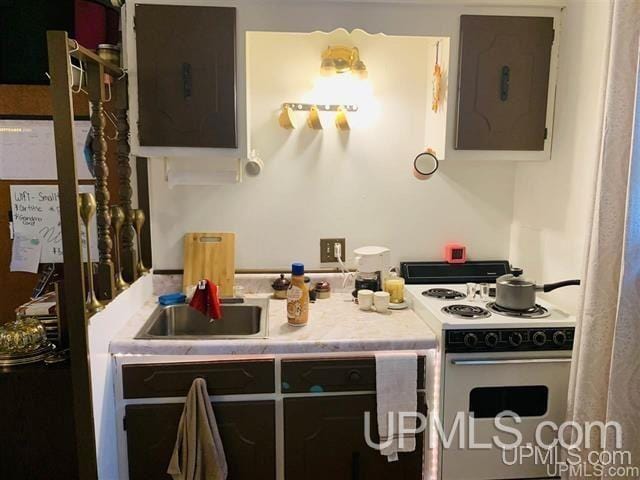 kitchen with electric range and dark brown cabinetry