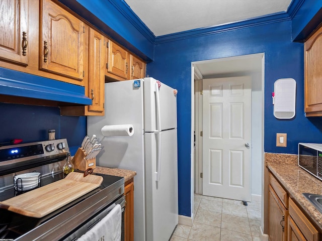 kitchen with brown cabinetry, ornamental molding, under cabinet range hood, and stainless steel electric range oven