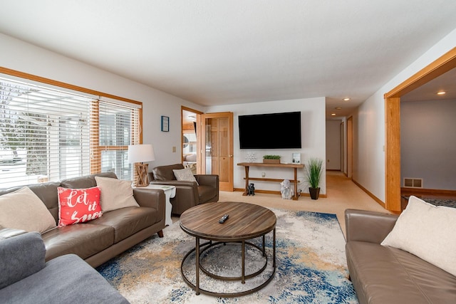 living area featuring visible vents, baseboards, and carpet floors