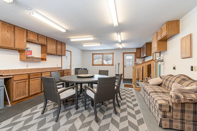 dining area with built in desk and concrete flooring