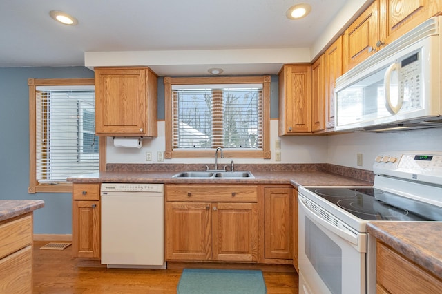 kitchen featuring a sink, visible vents, a wealth of natural light, and white appliances