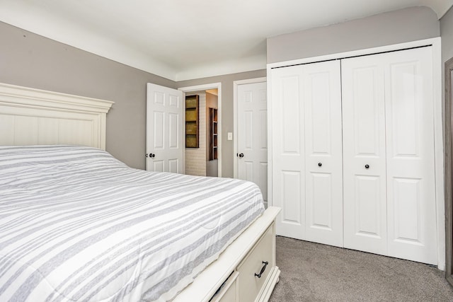 bedroom featuring a closet and light colored carpet