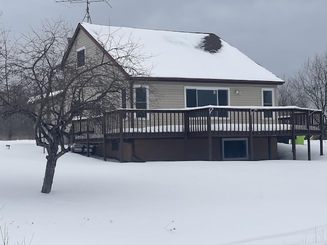 snow covered property featuring a deck