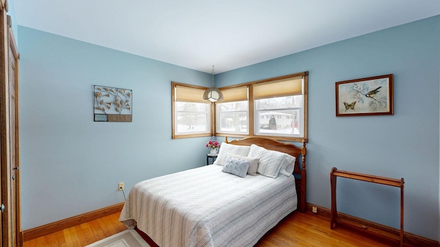 bedroom with light wood-style floors and baseboards