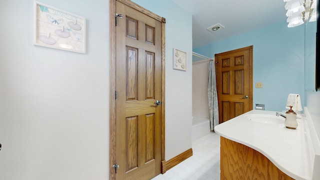 bathroom featuring visible vents, vanity, and tile patterned floors