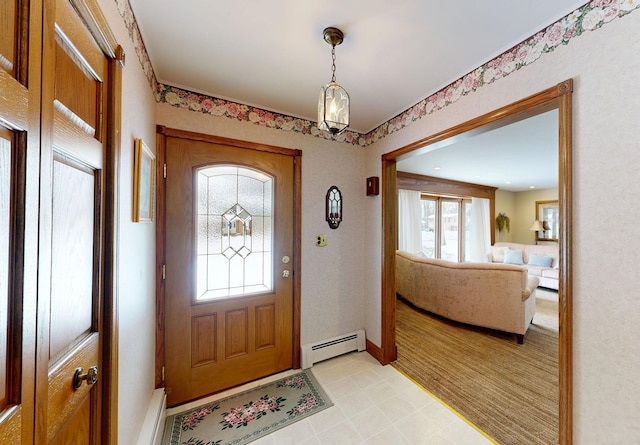 entrance foyer featuring a baseboard radiator, baseboards, and light floors