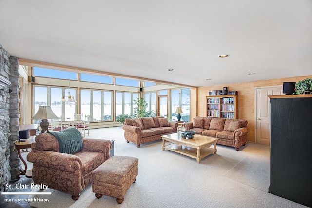 living room with recessed lighting, a healthy amount of sunlight, and light colored carpet